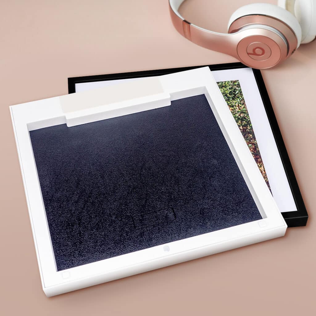 Rear side of a framed photo tile showing the self-adhesive stripe