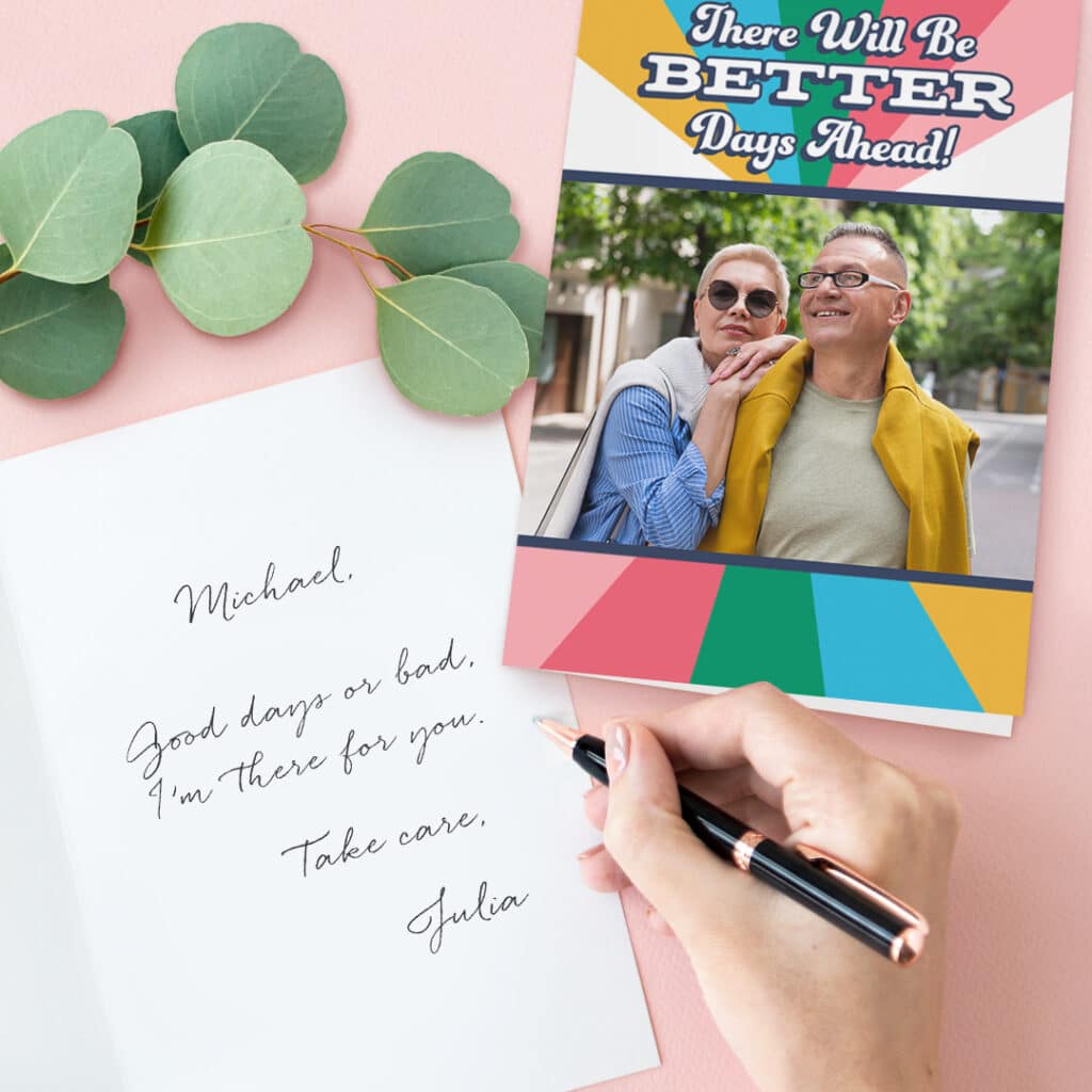 Greeting card displayed with a personal message being written